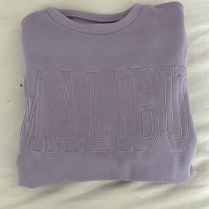 Shein. Says “MALIBU” on the front. Purple. Runs oversized.